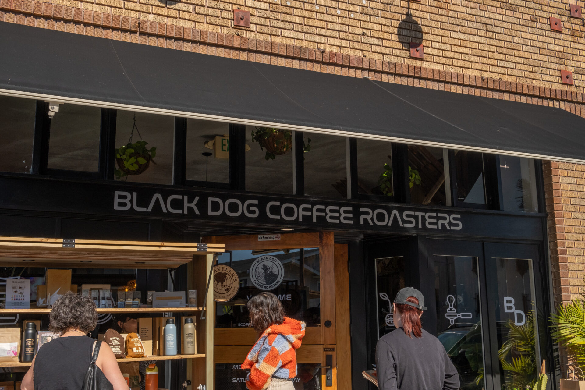 Front of Black Dog Coffee Roasters Coffee Shop with a kiosk selling TRC USA goods.