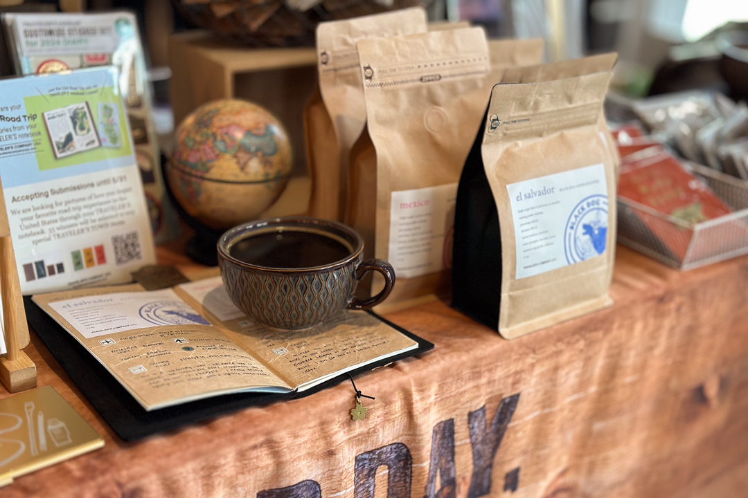 Close-up of TRC USA Pop-Up booth with TRAVELER'S COMPANY products with coffee beans from Black Dog Coffee Roasters.