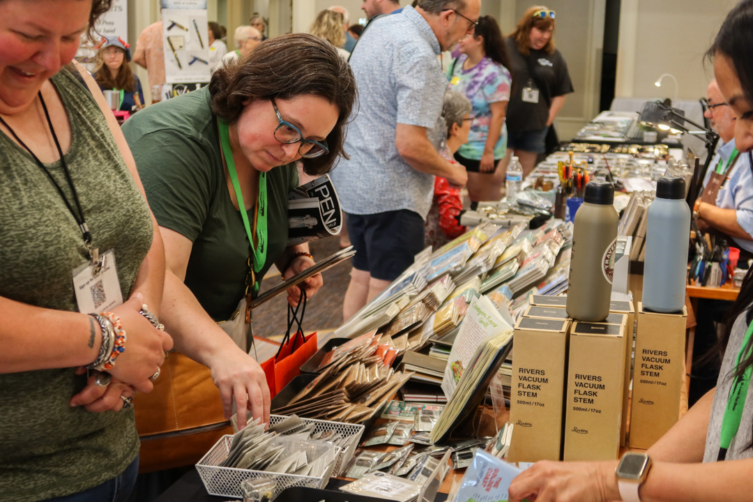 Customers browsed the TRAVELER'S COMPANY table at St. Louis Pen Show.