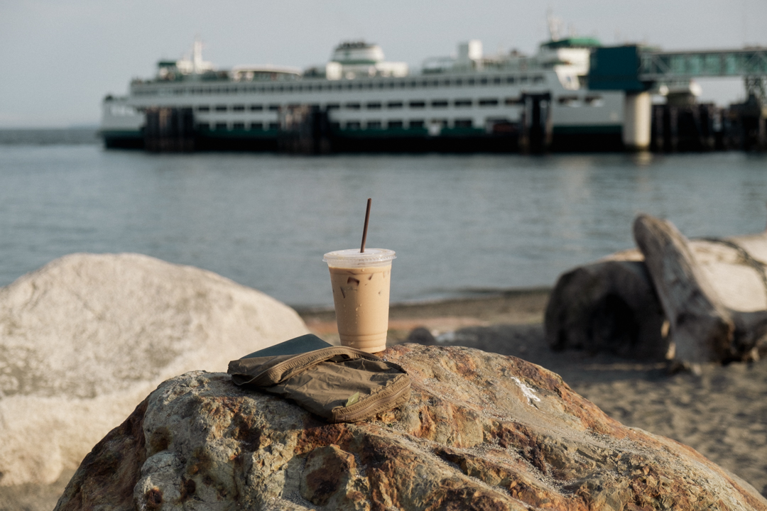 An iced coffee with TRAVELER'S notebook against the Washington Ferry at the dock of Edmonds.