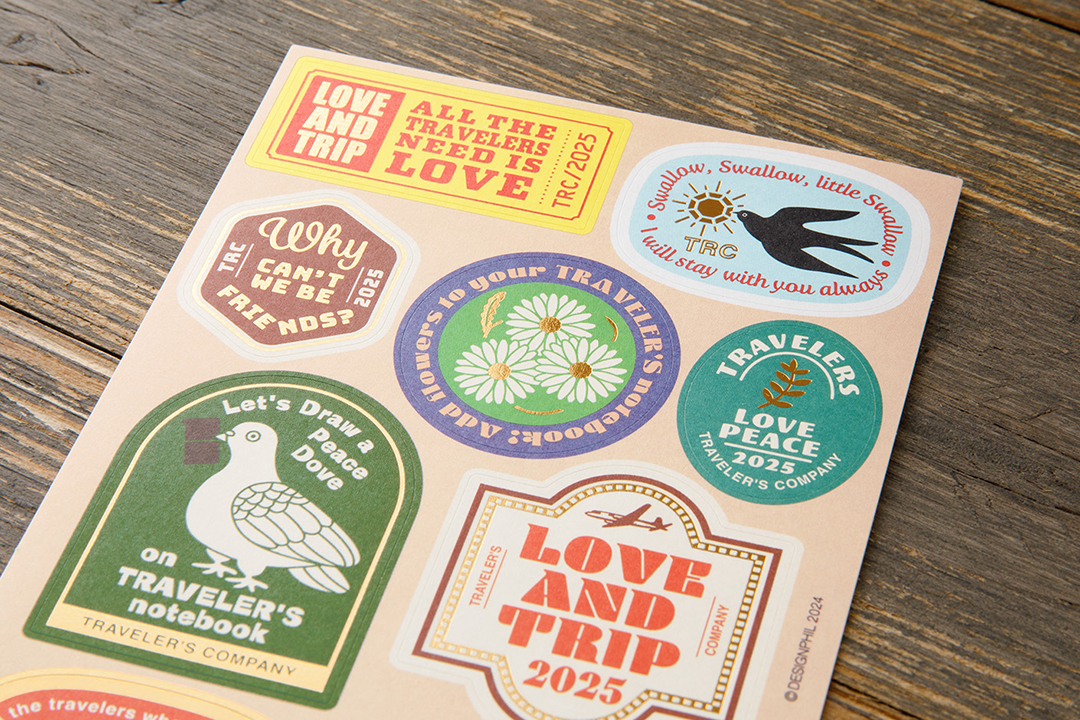 Close up look of LOVE AND TRIP Customized Sticker Set from the TRAVELER'S notebook 2025 DIARY collection.