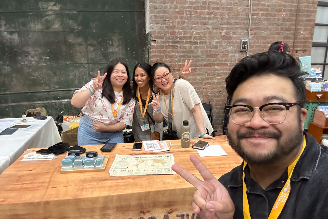 TRC USA staff taking a selfie in front of the TRC USA booth at Stationery Fest.