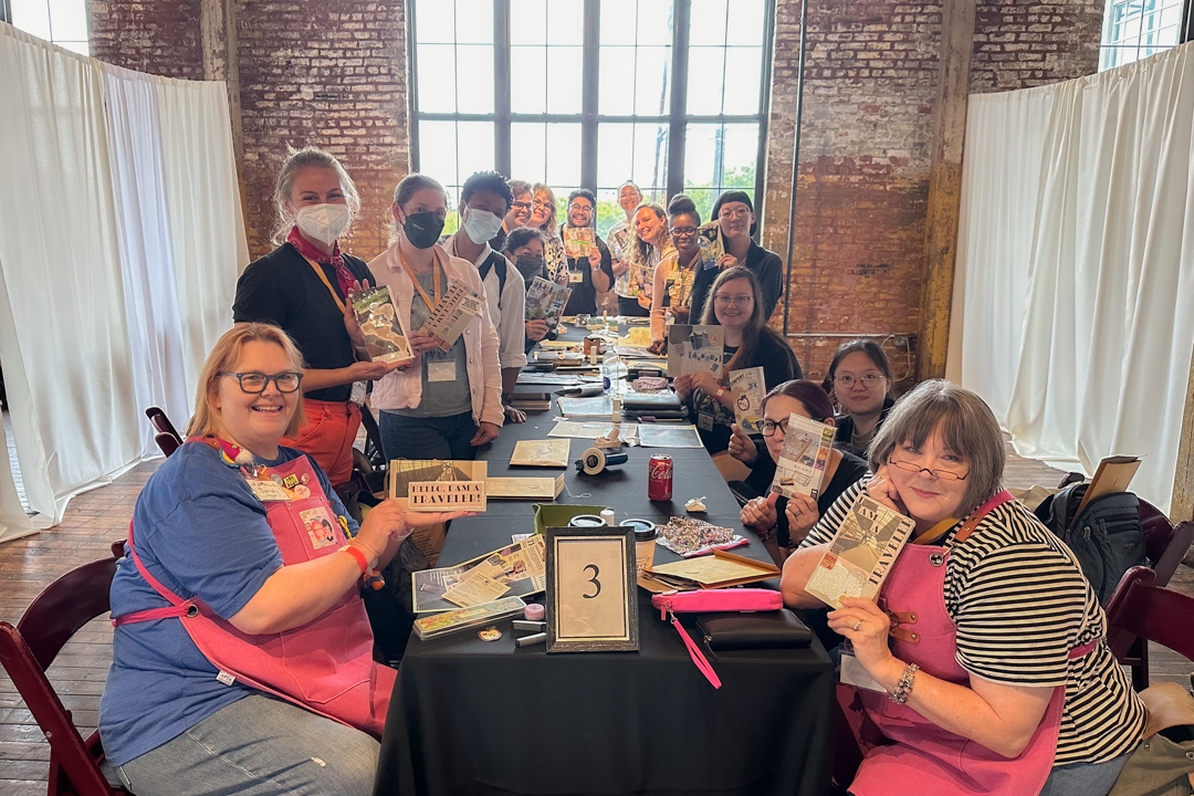 TRAVELER'S notebook users at a workshop posing together with their completed artwork.