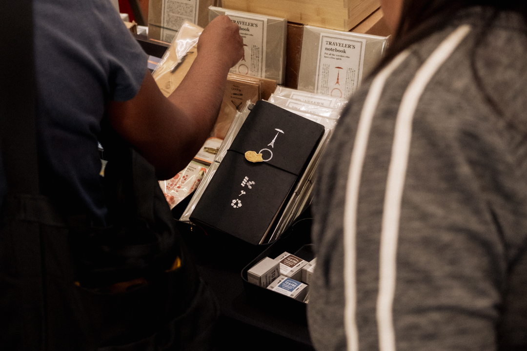 The TRAVELER'S notebook TOKYO Edition peeking through between crowds of fans.