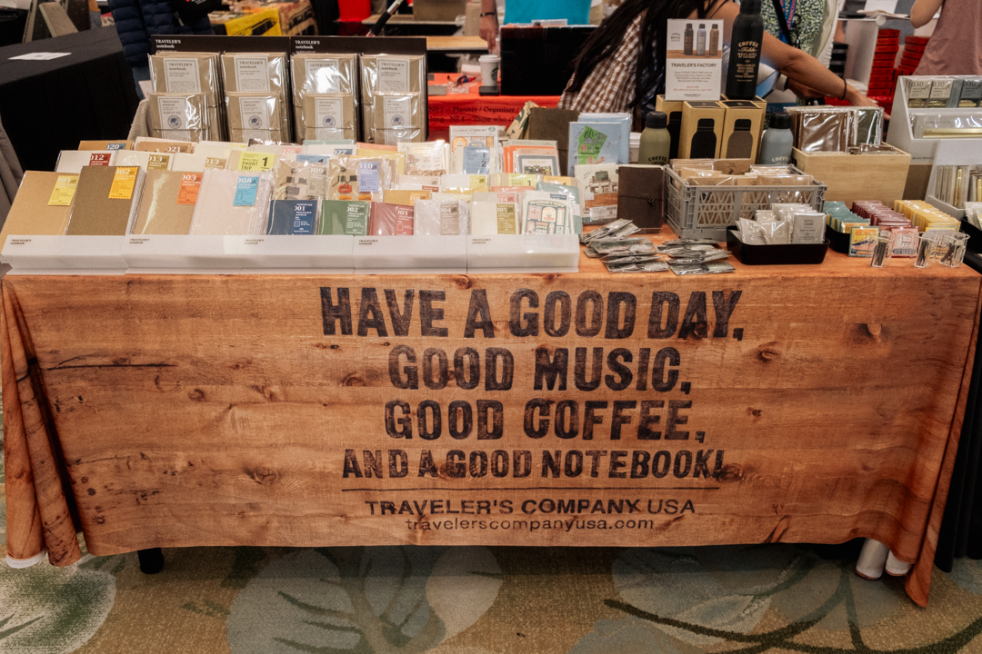 The display table of TRAVELER'S COMPANY USA featuring the "Have a Good Day" table cloth.