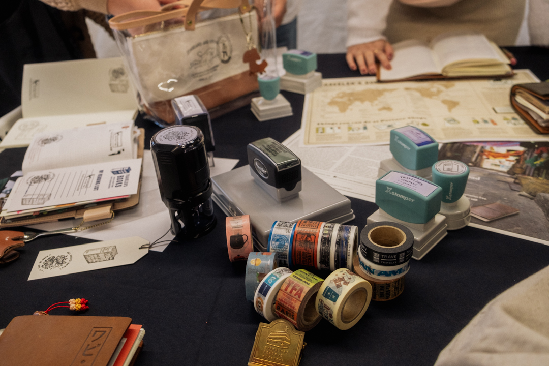 Close-up of people stamping their notebooks and sharing their stationery in the KUBO LB store.