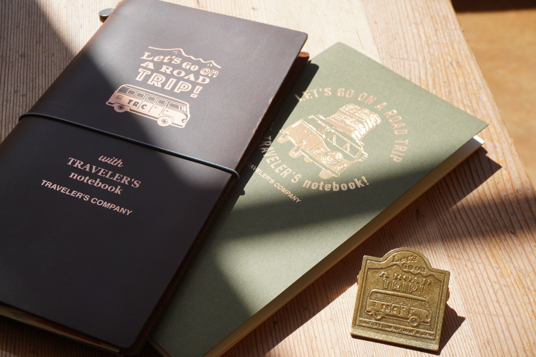 A TRAVELER'S notebook USA Road Trip Edition with notebook and brass clip on a table.