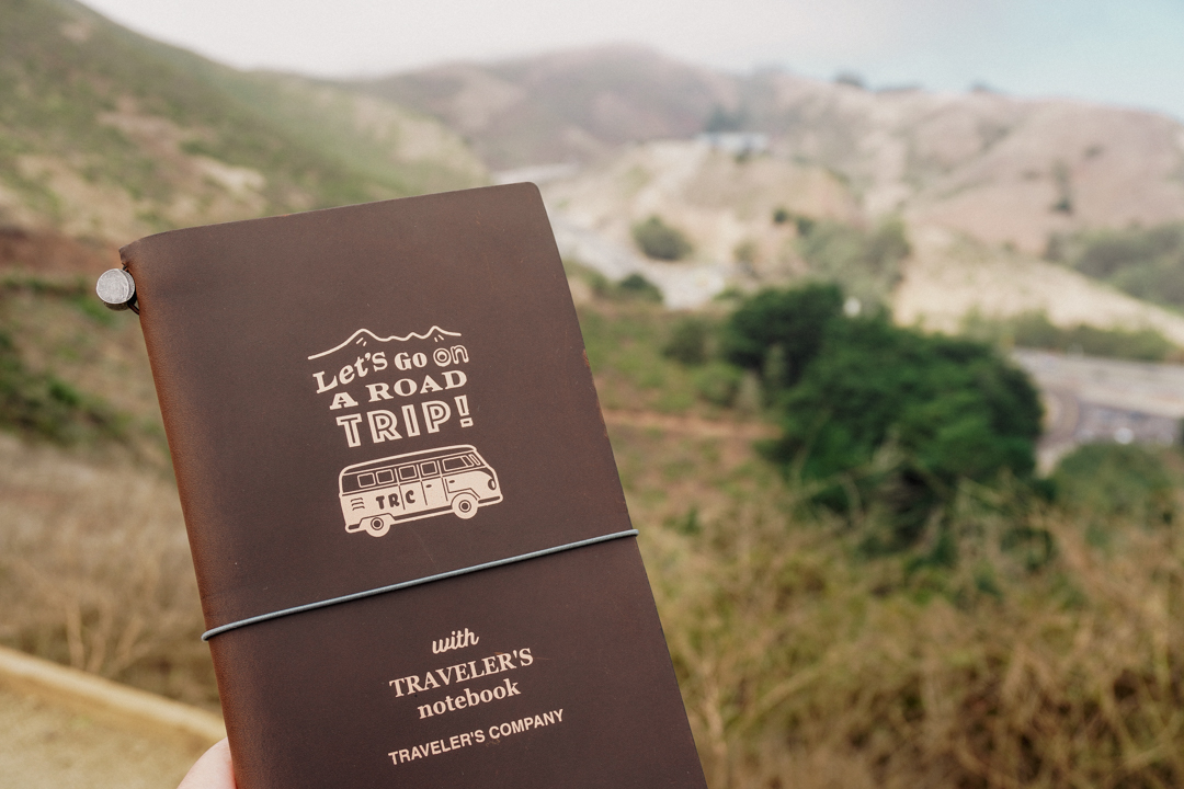 TRAVELER'S notebook USA Road Trip against the hills of San Francisco.