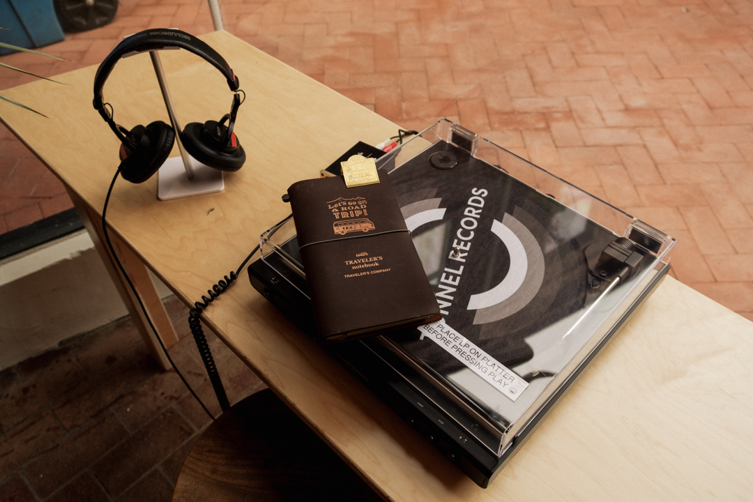 TRAVELER'S notebook on top of a vinyl turntable.