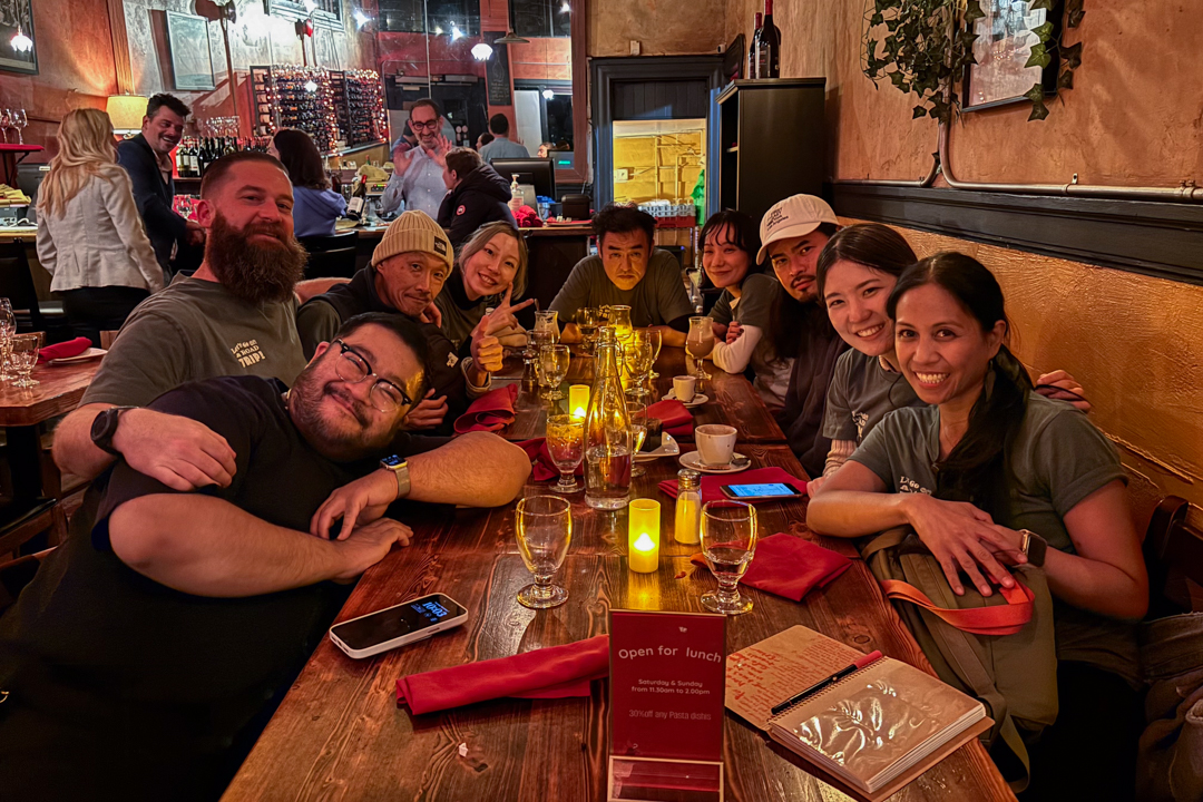 TRC team posing at an Italian restaurant, celebrating the Road Trip Caravan events.