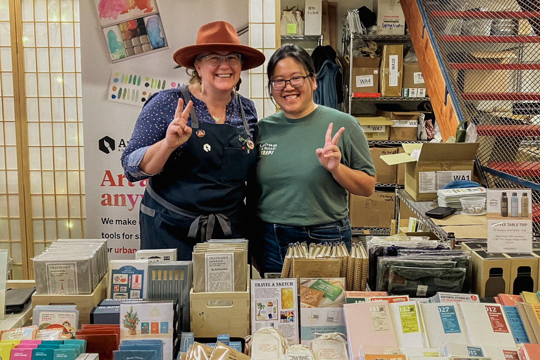 TRC team posing in front of the TRC products at the Art Toolkit Store.