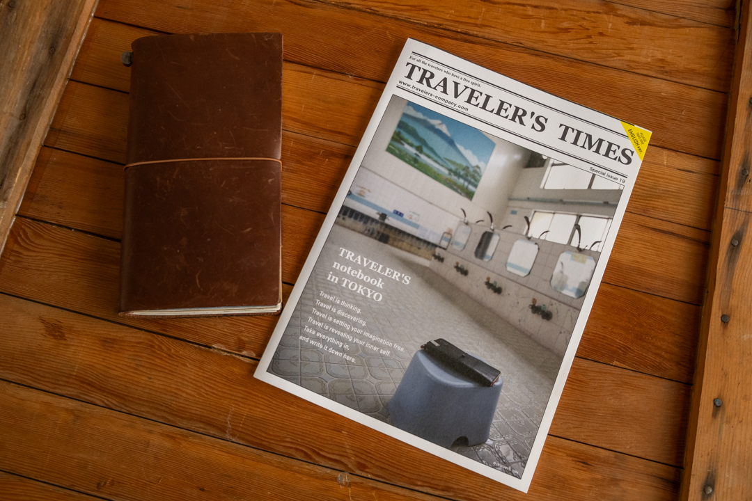 TRAVELER'S TIMES Vol 19 next to a TRAVELER'S notebook.