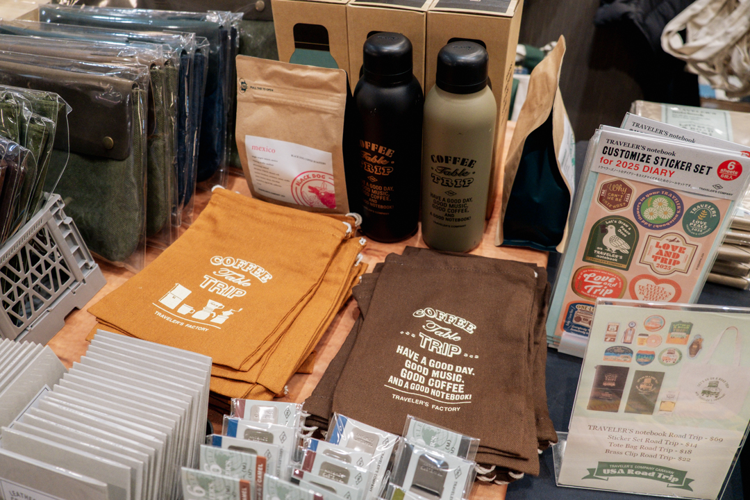 COFFEE TABLE TRIP items like the canvas bags, coffee beans and TF Original Water Bottles TRC USA capsule machine on the TRC USA table at the California Pen Show.