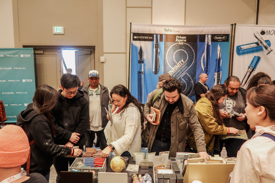 TRAVELER'S notebook fans and customers shopping at the TRC USA table in the California Pen Show.