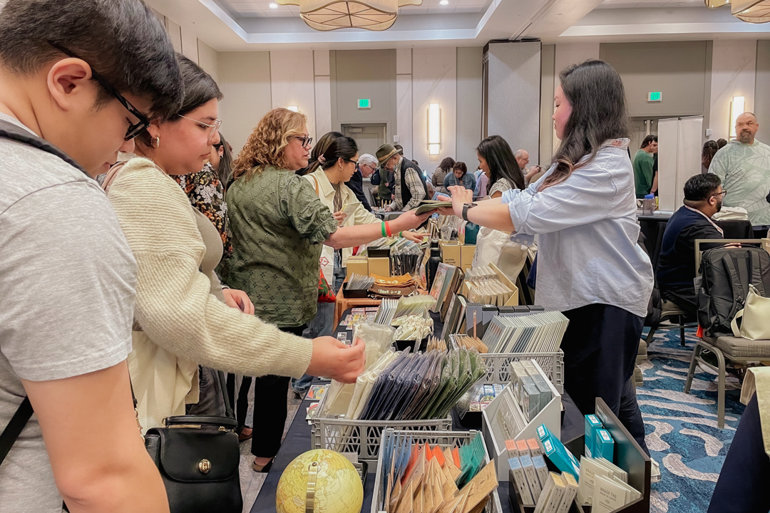 TRC USA staff showing and selling items from the TRC USA table at the California Pen Show.