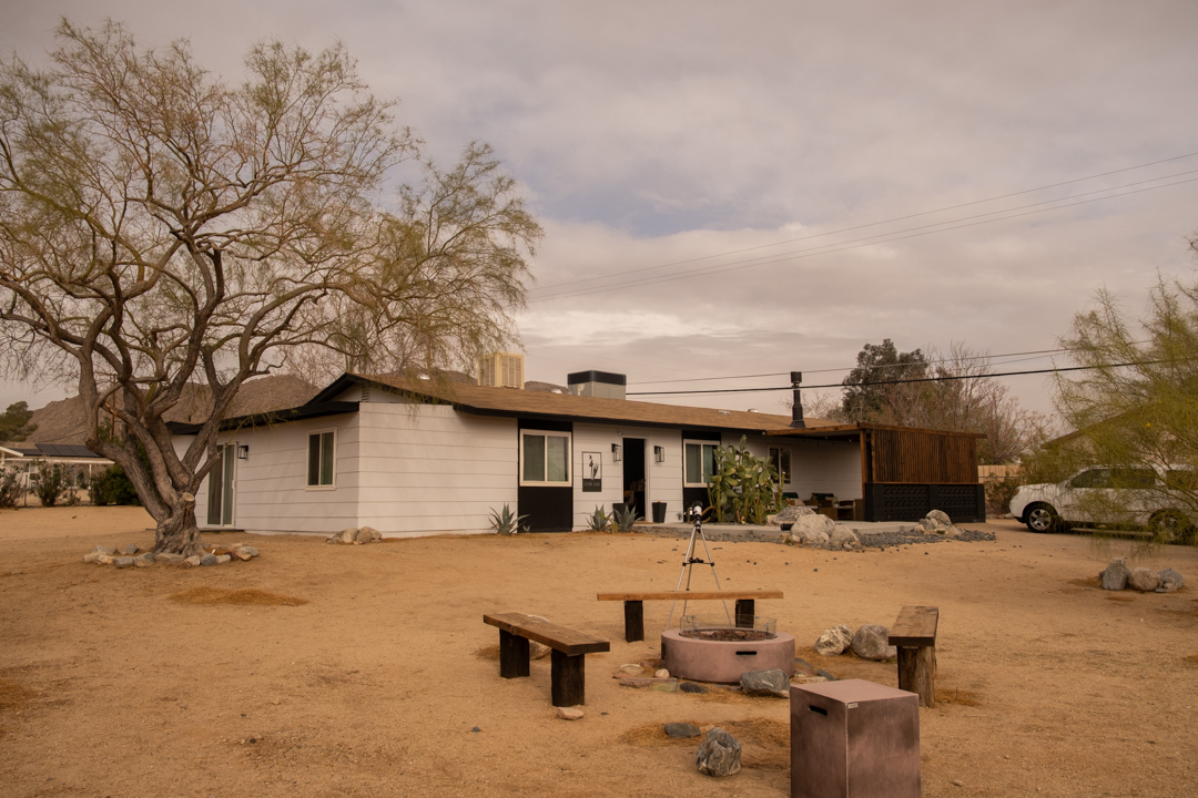 The exterior of a white guest house in Joshua Tree, California.