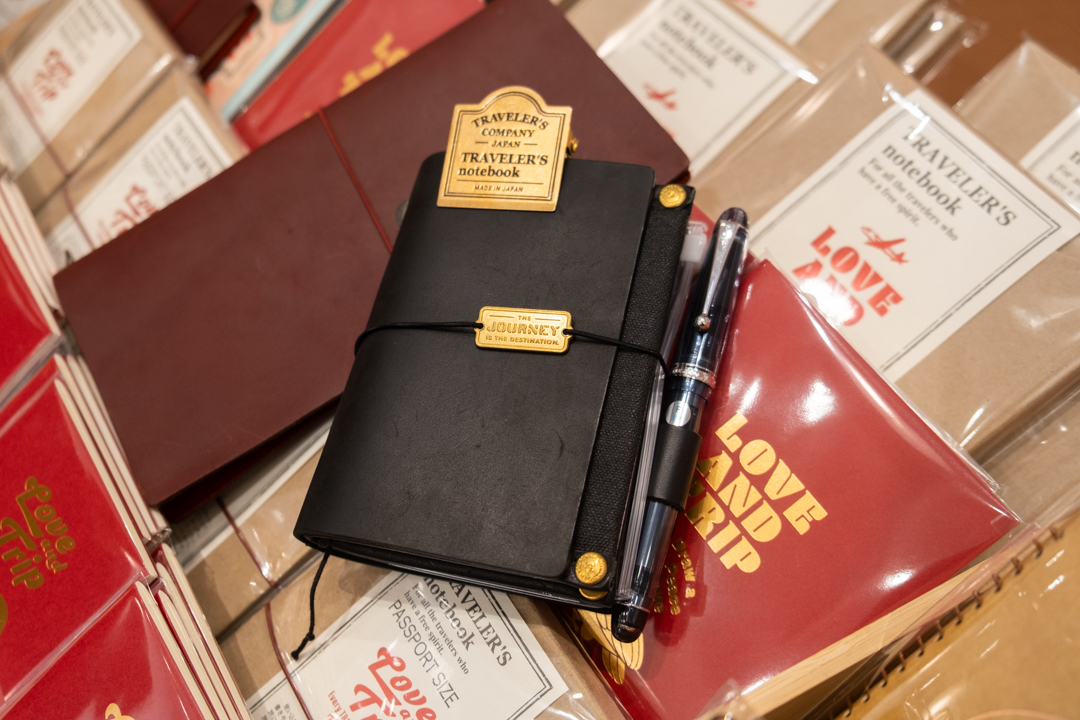 A customized black TRAVELER'S notebook on top of the TRAVELER'S notebook display.