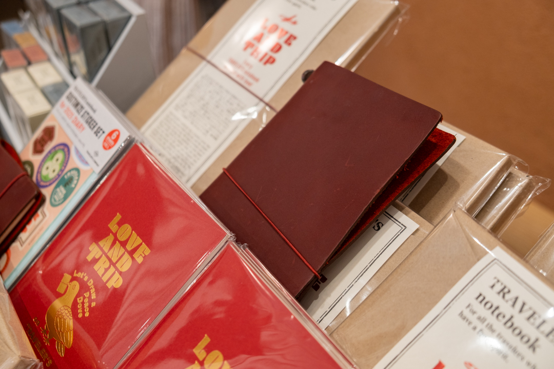 A LOVE AND TRIP red TRAVELER'S notebook in the TRC USA display.