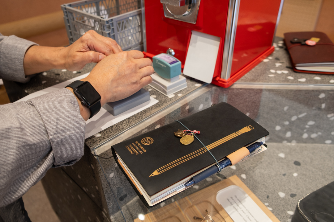 A TRAVELER'S notebook fan's using the TRAVELER'S notebook stamps beside their limited edition Blackwing TRAVELER'S notebook.