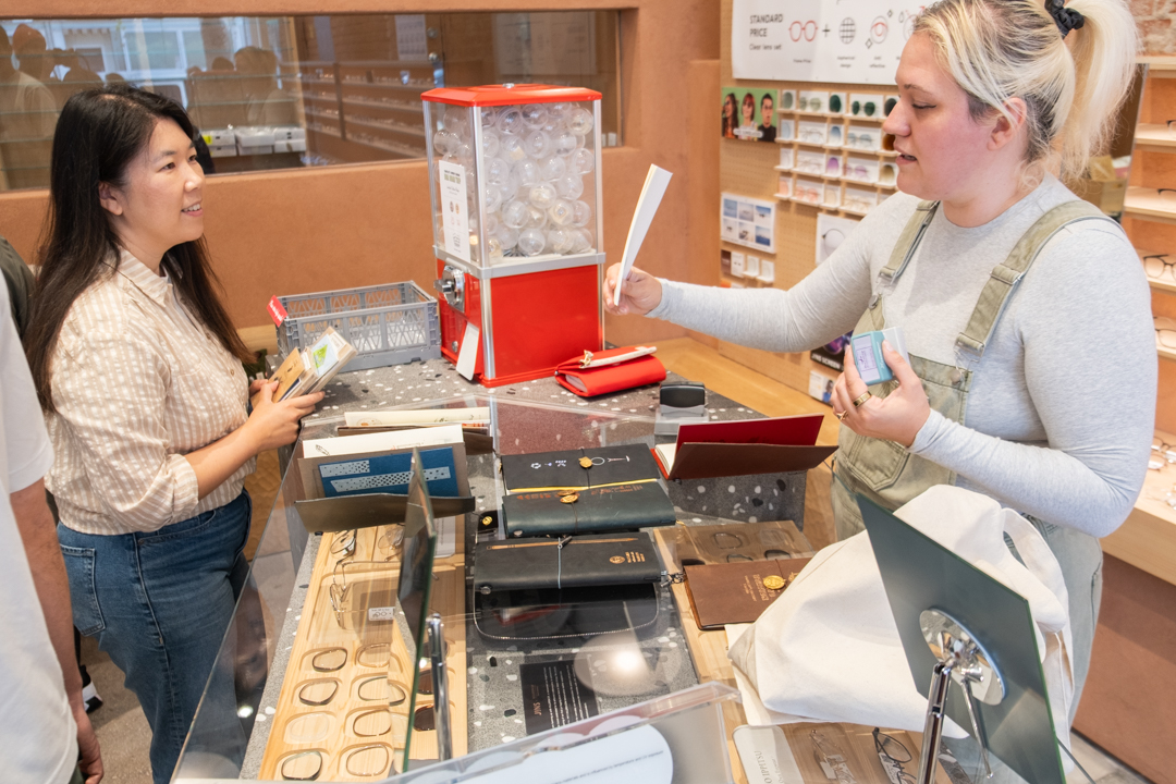Customers trying the TRC USA capsule machine to get an event button. 