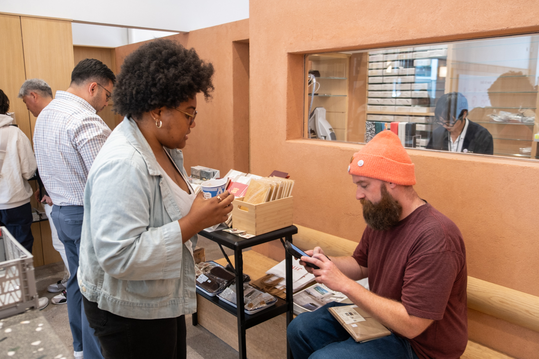 People shopping for TRAVELER'S notebooks and related accessories at the TRC USA pop-up at JINS Abbot Kinney.