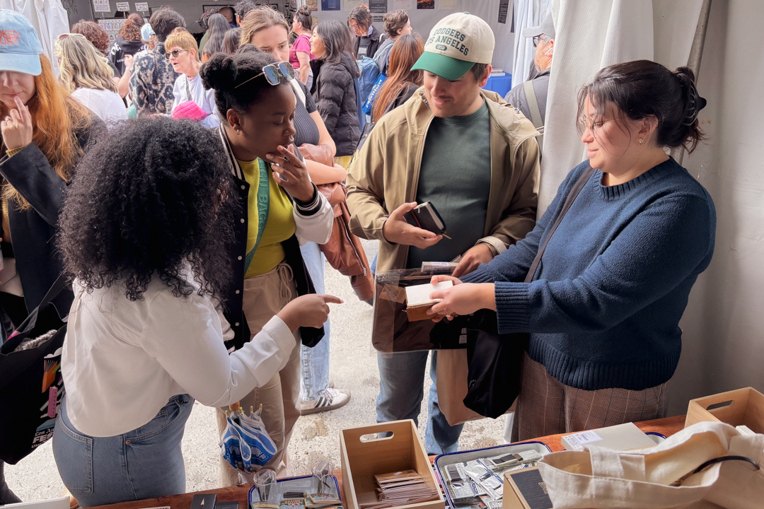Returning TRC USA customers helping new customers decide which items and notebooks to purchase at the TRC USA booth.