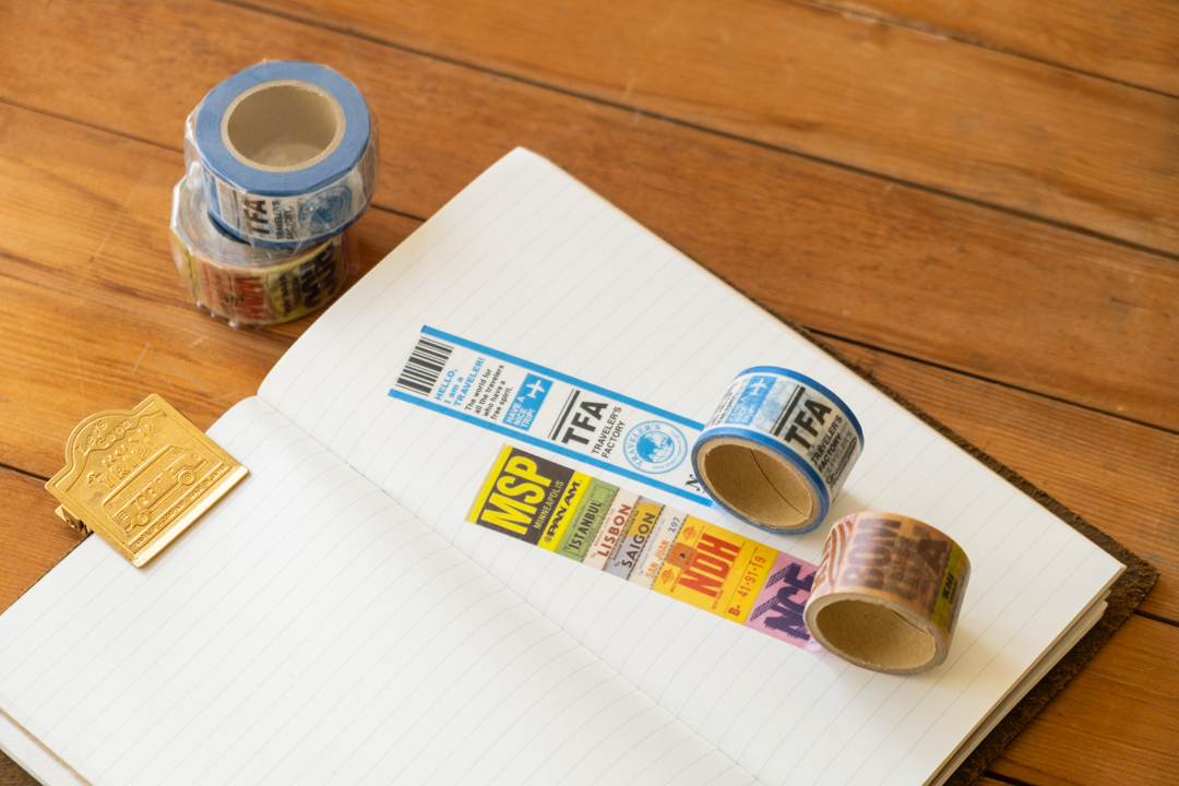 TRAVELER'S FACTORY masking tapes rolled onto a blank page of a TRAVELER'S notebook.