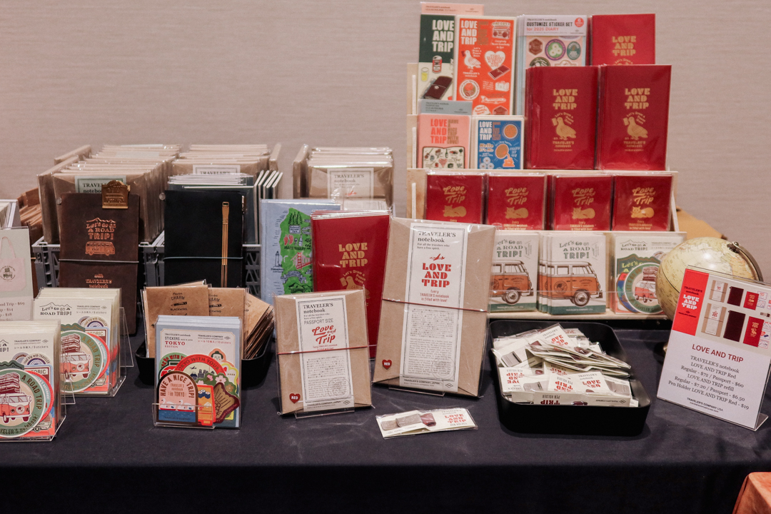 The LOVE AND TRIP red TRAVELER'S notebook collection at the TRC USA table at Little Craft Fest.