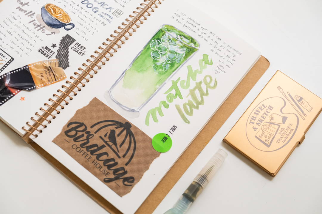A painting of a matcha latte in the TRAVEL &SKETCH SPIRAL RING notebook. On the bottom half of the page is a torn piece of cup sleeve from the cafe Birdcage Coffee House.