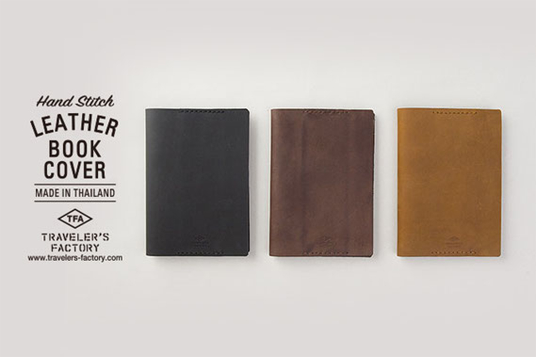 Three leather book covers in black, brown and camel leather on a grey background.