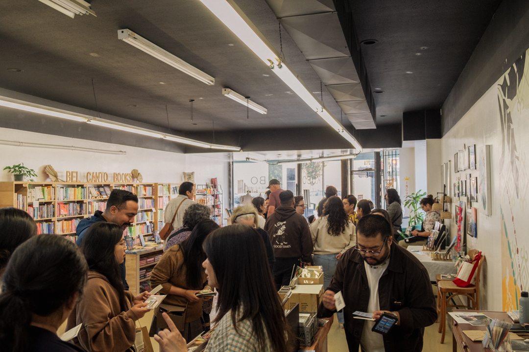 Busy interior of KUBO LB, Long Beach filled with people shopping for books and TRAVELER'S notebooks.