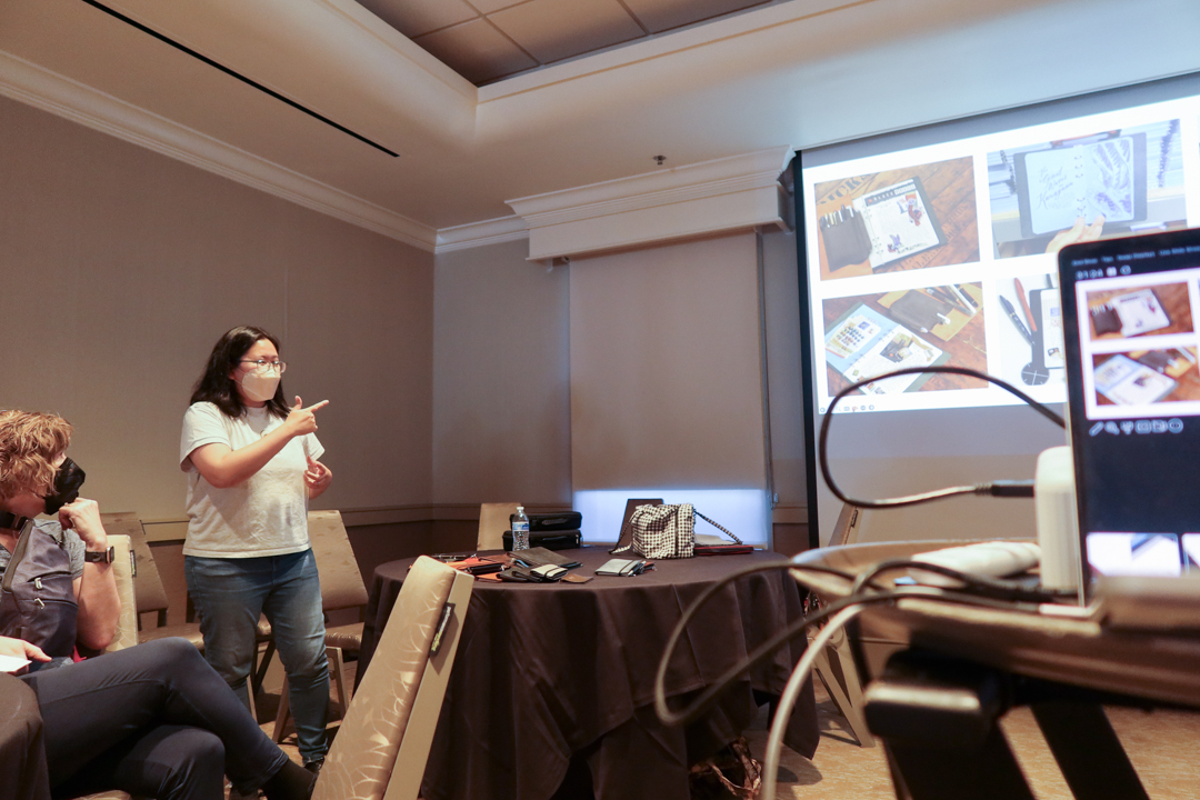 TRC USA staff presenting a powerpoint presentation about TRC USA at the LOVE and TRIP Meetup and Panel event at the SF Pen Show.