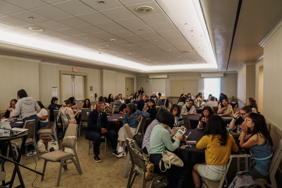 The crowd of attendees watching a PowerPoint presentation about TRC USA at the LOVE and TRIP Meetup and Panel event at the SF Pen Show.