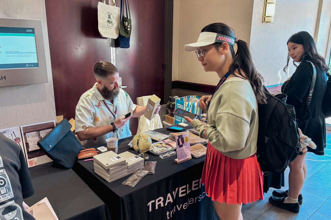 A person ringing up a customer's TRC USA purchases at the SF Pen Show.