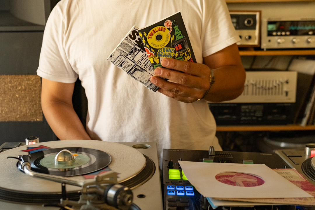 Hector holding two special edition TRAVELER'S notebook refill TWELVES RECORD (Passport Size).
