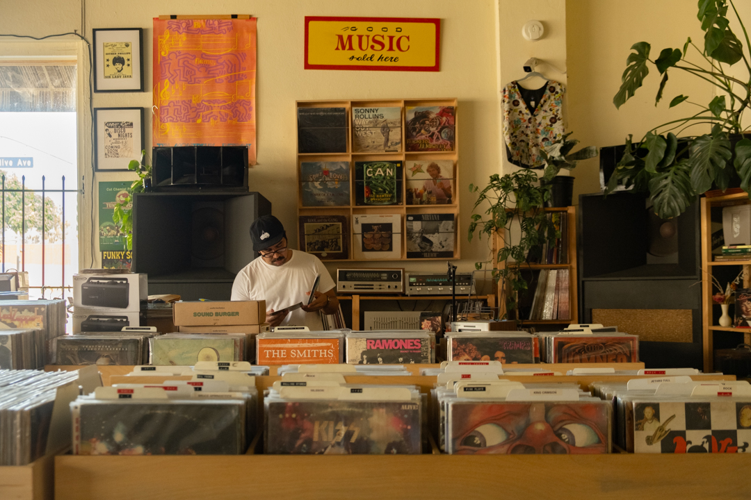 Hector picking out a record by his DJ station.