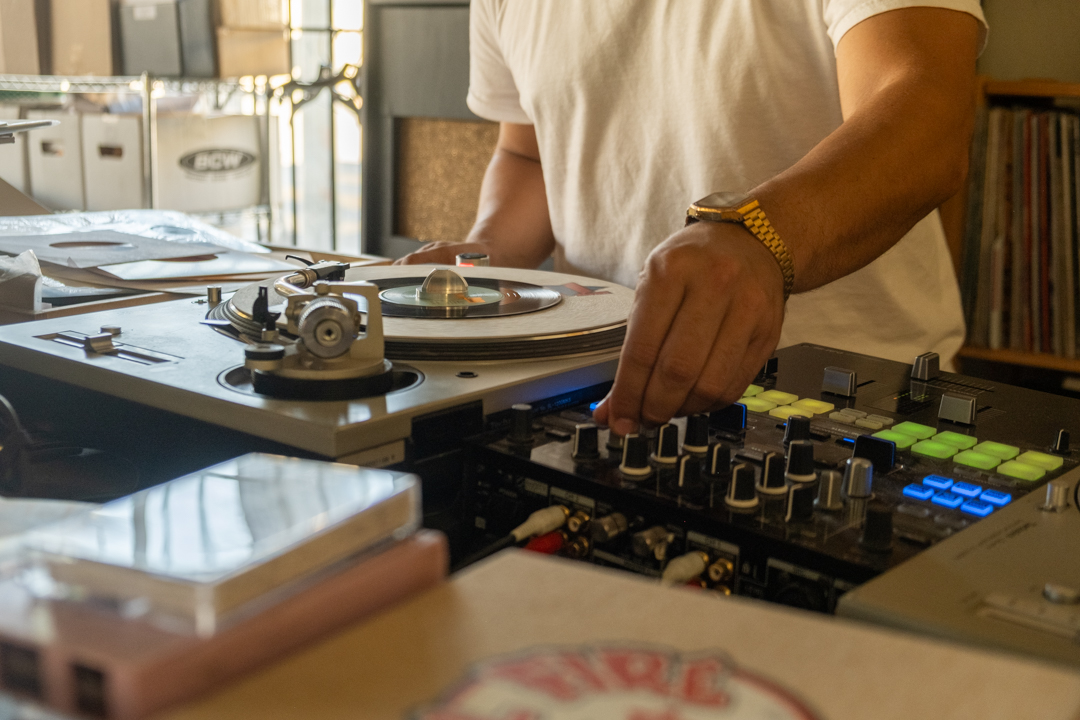 Shop owner Hector adjusted the volume on the record player.