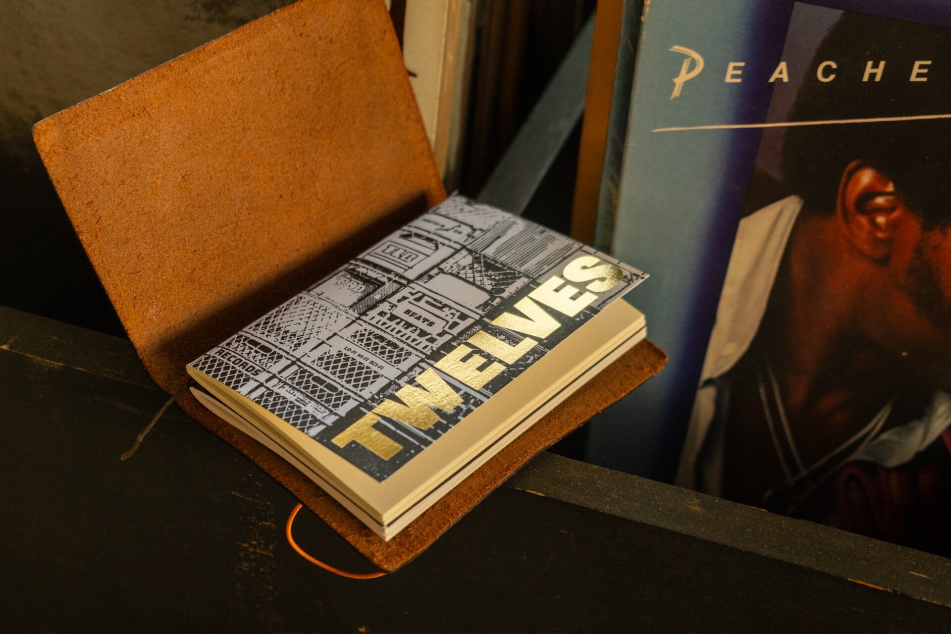 "Crate" TRAVELER'S notebook refill (Passport Size) sitting on a bin of vinyls.