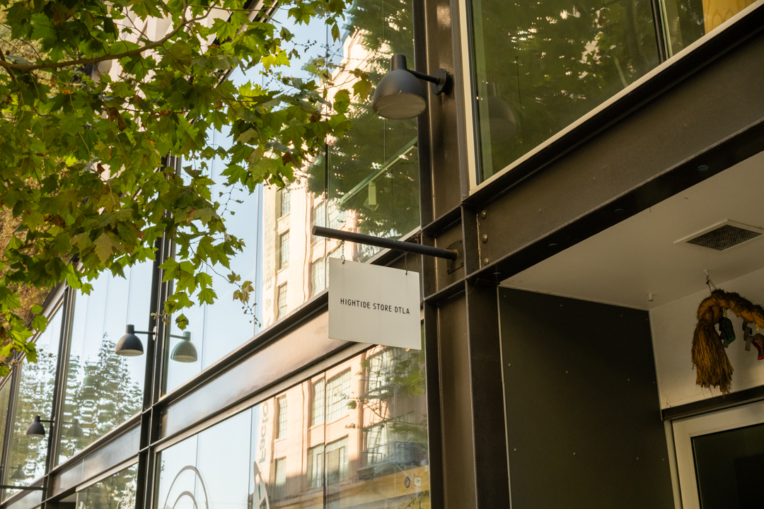 The welcoming exterior of HIGHTIDE STORE DTLA, framed by lush greenery and modern architecture.