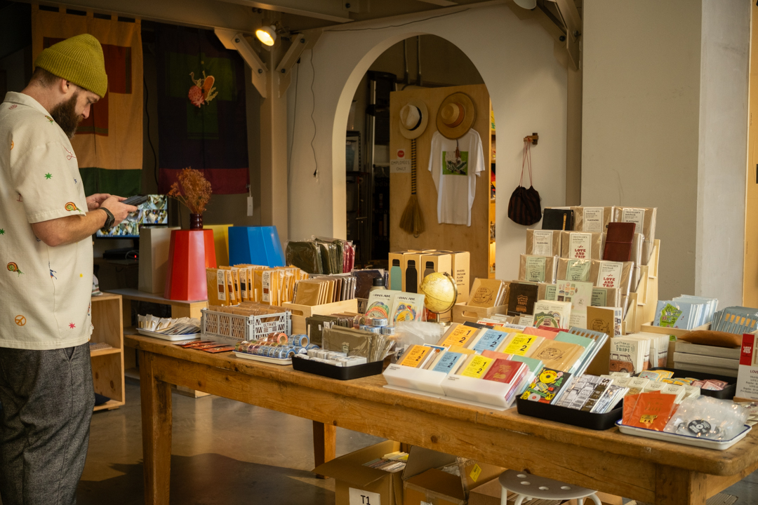 The main TRAVELER'S FACTORY pop-up display table showcasing the full range of notebooks, accessories, and stationery products.