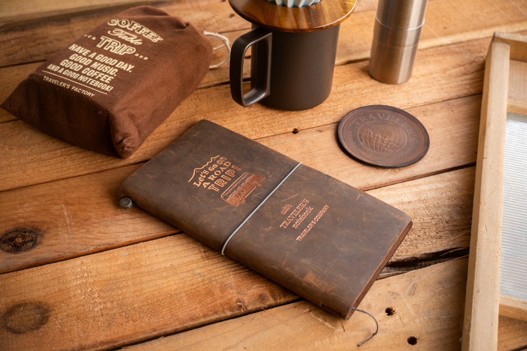 A TRAVELER'S notebook ROAD TRIP Brown with TF Coffee Bag in Dark Brown.