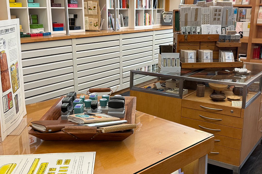 Two storage display cabinets are used to display the TRAVELER'S COMPANY Stamp Caravan event.