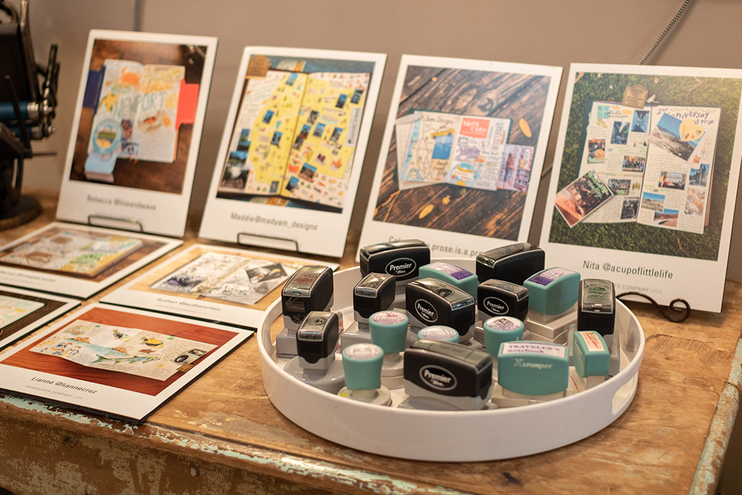 A display of LOVE AND TRIP contest winners next to a tray of stamps.