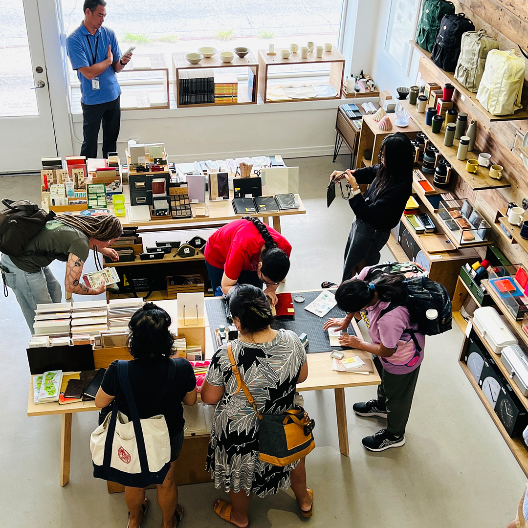 An overhead view of customers visiting the Stamp Caravan event inside the Mono store.