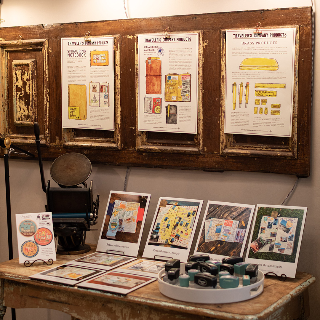 A display of Stamp Caravan stamps and information about TRAVELER'S COMPANY on the billboard.