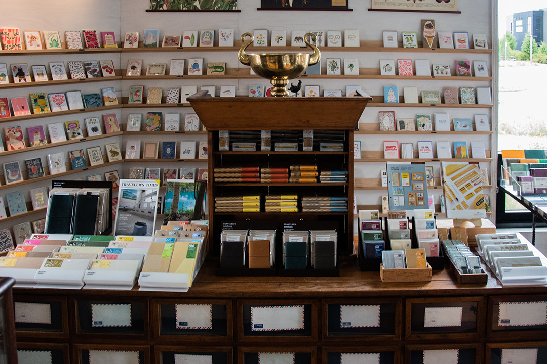 Inside the store of Paper and Grace with walls lined with greeting cards.