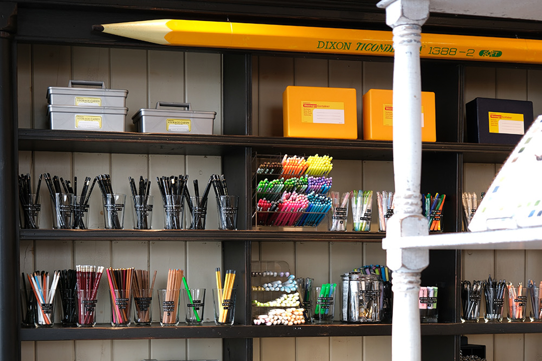 The interior of Paper and Grace stationery shop is filled with pens, inks, paper goods, stationery and beautiful vintage wooden decor and dried flowers.