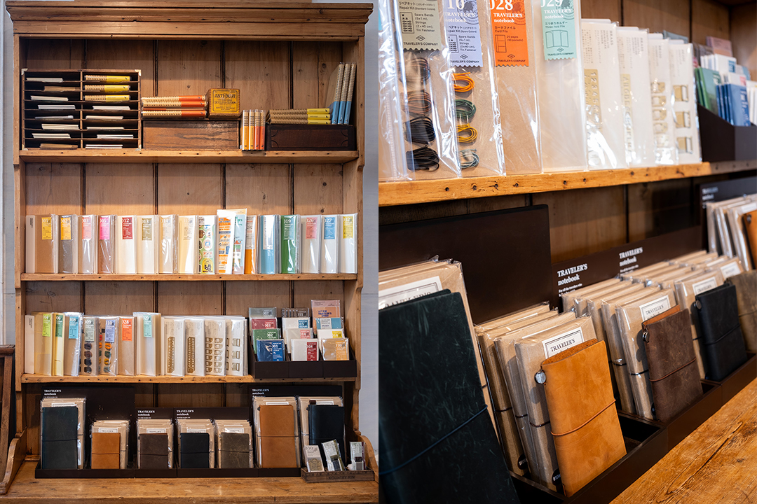 The interior of Paper and Grace stationery shop is filled with TRAVELER'S COMPANY items, such as TRAVELER'S notebooks, refills, and other paper goods and stationery, which are displayed on beautiful vintage wooden shelves and tables.