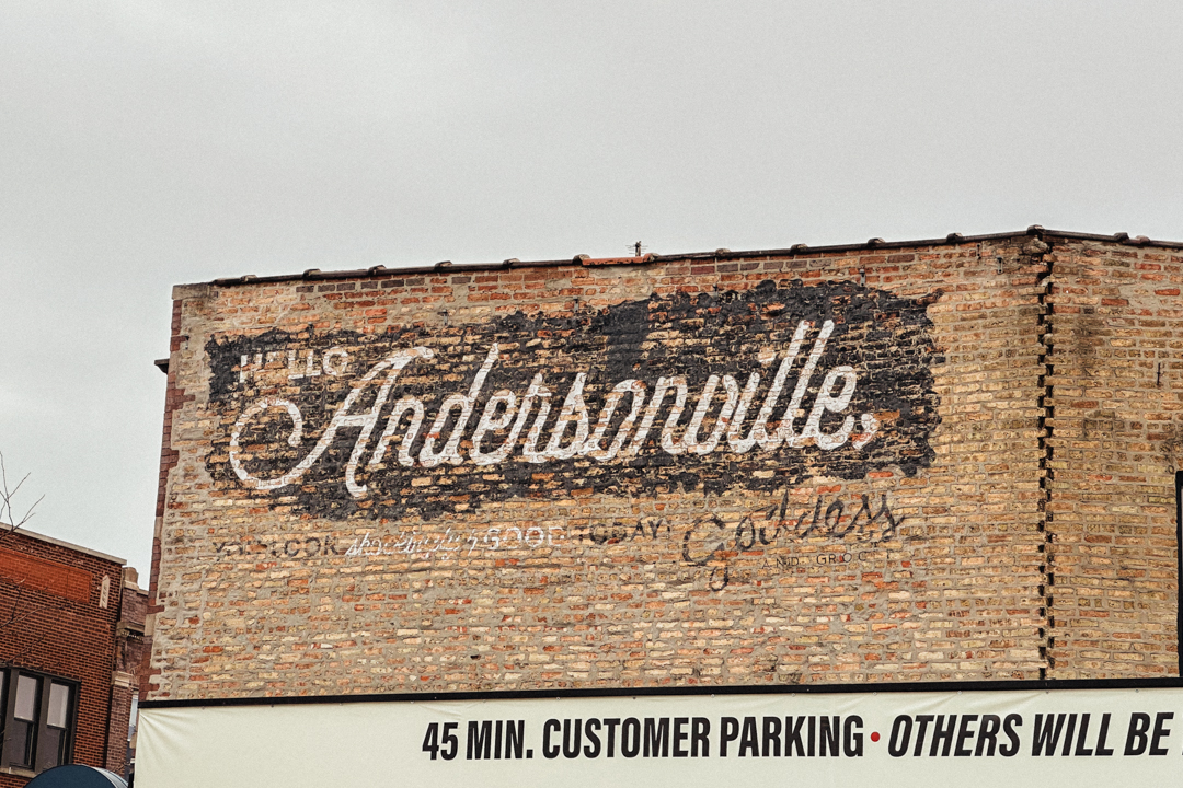 A brick building with a vintage painted sign entitled "Andersonville," which is located in Andersonville, Chicago.