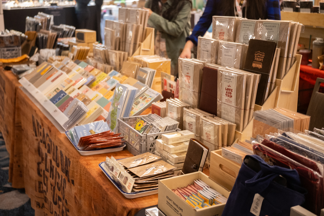 Fully stocked notebooks and other stationery at the TRAVELER'S COMPANY USA table at the California pen show.